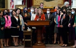 FILE - Texas state Rep. Donna Howard, D-Austin, center, speaks against a bill that would ban abortions as early as six weeks and allow private citizens to enforce it through civil lawsuits, in the House Chamber in Austin, Texas, May 5, 2021.