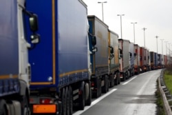 FILE - Trucks queue along the A16 motorway to board ferries to reach England, near Calais, France, Dec. 9, 2020. British-EU trade talks were teetering Dec. 12, 2020.