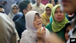 A relative of passengers prays as she and others wait for news on a Lion Air plane that crashed off Java Island at Depati Amir Airport in Pangkal Pinang, Indonesia, Oct. 29, 2018. 