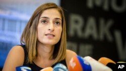 Journalist Mesale Tolu answers to questions of journalists at the airport of Stuttgart, Germany, Aug. 26, 2018. 