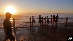 FILE - Sunset over the promenade in Cape Town, South Africa, Aug. 24, 2014.