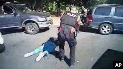 This image made from video provided by the Charlotte-Mecklenburg Police Department, Sept. 24, 2016, shows Keith Scott on the ground as police approach him in Charlotte, N.C., on Sept. 20, 2016. 