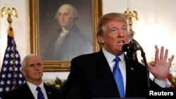 U.S. Vice President Mike Pence listens as U.S. President Donald Trump announces that the United States recognizes Jerusalem as the capital of Israel and will move its embassy there, during an address from the White House, Dec. 6, 2017.