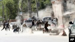 Britain's Prince Charles, center, and Prime Minister Boris Johnson, right, shelter from rain during the unveiling of the UK Police Memorial at the National Memorial Arboretum at Alrewas, England.