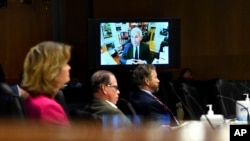FILE - Senators listen as Dr. Anthony Fauci, director of the National Institute of Allergy and Infectious Diseases, speaks remotely during a virtual Senate Committee for Health, Education, Labor, and Pensions hearing on Capitol Hill, May 12, 2020.