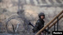 A South Korean soldier walks up the stairs at an observation post, near the demilitarized zone that separates the two Koreas, in Paju, north of Seoul, March 12, 2013. 
