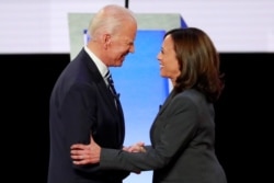 Former Vice President Joe Biden and Senator Kamala Harris shake hands before the start of the second night of the second 2020 presidential Democratic candidates debate in Detroit, July 31, 2019.