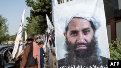 FILE - A poster of Taliban Supreme Leader Hibatullah Akhundzada is seen along a road in Kabul, Aug. 14, 2023. ICC chief prosecutor’s announced, Jan. 23, 2025, seeking arrest warrants for Akhundzada and a close associate accused of crimes against humanity.
