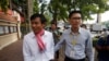 FILE - Journalists Uon Chhin, left, and Yeang Sothearin arrive at municipal court in Phnom Penh, Oct. 3, 2019.