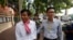 FILE - Journalists Uon Chhin, left, and Yeang Sothearin arrive at municipal court in Phnom Penh, Oct. 3, 2019.