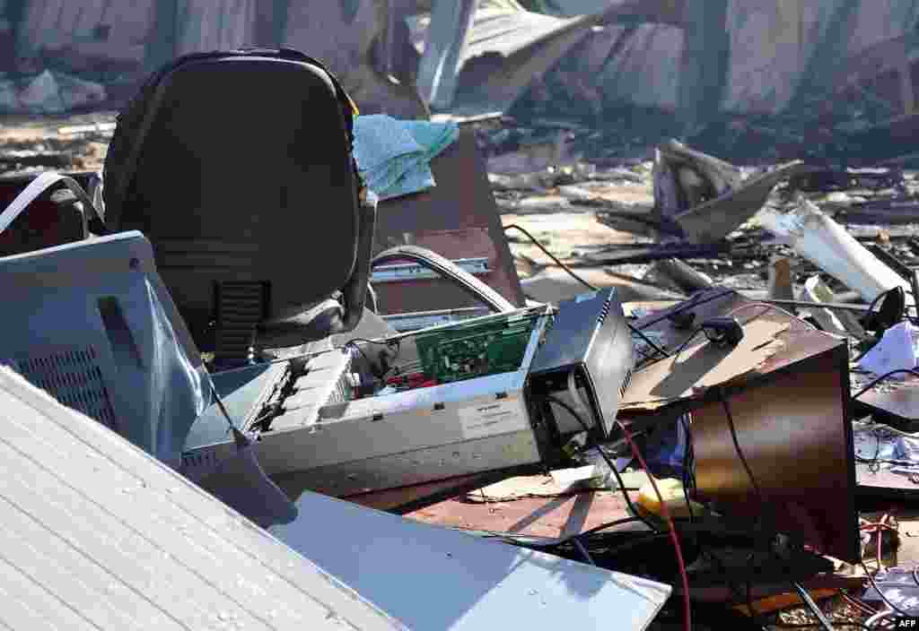 Damaged equipment at the site of an attack on the pro-government al-Ikbariya satellite television channel's offices outside Damascus