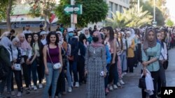 Syrian students show up to votes at a polling station during the presidential election in the capital, Damascus, May 26, 2021.