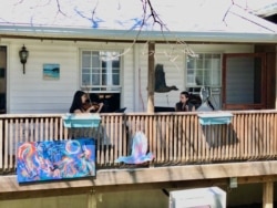 The Milo trio play a few classical favorites from the porch of pianist Carl Banner's house in Takoma Park, Maryland, March 30, 2020. (Julie Taboh/VOA)