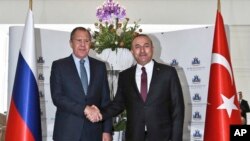 Russian Foreign Minister Sergei Lavrov, left, and Turkish Foreign Minister Mevlut Cavusoglu shake hands before a meeting of Turkey-Russia joint strategic planning group in Alanya, Antalya, Turkey, Dec. 1, 2016. 