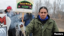Protesters block highway 1806 in Mandan, North Dakota, during a protest against plans to pass the Dakota Access pipeline near the Standing Rock Indian Reservation, Nov. 23, 2016.