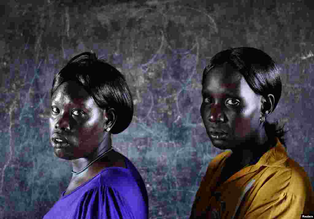 Women wait to vote inside a polling station located in a school during a referendum in the town of Abyei, Oct. 28, 2013. 