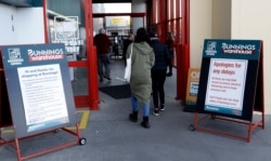 Customers enter a hardware store in Christchurch, New Zealand, May 14, 2020. New Zealand lifted most of its remaining lockdown restrictions as the country prepares for a new normal.