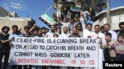Residents hold a banner during a protest against Syria's President Bashar al-Assad in Kafranbel near Idlib October 19, 2012.