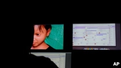 FILE - A Terre des Hommes researcher chats in a public chat room where users solicit fake 10-year-old Sweetie from the Philippines, top in a computer-generated image, in Amsterdam, Netherlands