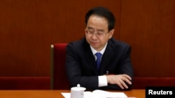 FILE - Ling Jihua pauses while attending the opening ceremony of the Chinese People's Political Consultative Conference (CPPCC) at the Great Hall of the People in Beijing, March 3, 2013. Ling was placed under investigation in late 2014 and was formally arrested in July 2015.
