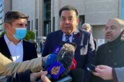 Yasin Aktay, adviser to Turkish President Recep Tayyip Erdogan, and Egyptian politician Ayman Noor talk to media after a trial on the killing of Saudi journalist Jamal Khashoggi at the Saudi Arabian Consulate, in Istanbul, Turkey, Nov. 24, 2020.