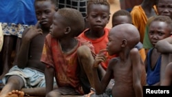 FILE - Orphans and children separated from their parents in Kadugli gather for food at an internally displaced persons camp in Boram County, Nuba Mountains, South Kordofan, Sudan, June 22, 2024.