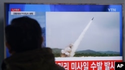 FILE - A man watches a TV news program showing file footage of missile launch conducted by North Korea, March 3, 2016. 