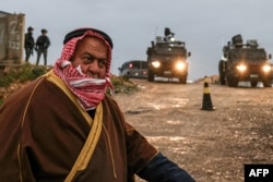 A Palestinian Muslim walks across an Israeli checkpoint in Qalandia in the occupied West Bank to attend the first Friday prayers of the fasting month of Ramadan at the Al-Aqsa Mosque compound in east Jerusalem on March 7, 2025.