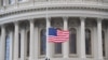 A U.S. flag is raised at the U.S. Capitol in Washington, Jan. 20, 2021.