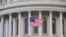 A U.S. flag is raised at the U.S. Capitol in Washington, Jan. 20, 2021.