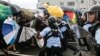 Police try to disperse protesters near a flag-raising ceremony for the anniversary of Hong Kong handover to China in Hong Kong, July 1, 2019.