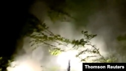 Police officers aim their weapons towards protesters demonstrating in Portland, Sep 24, 2020.