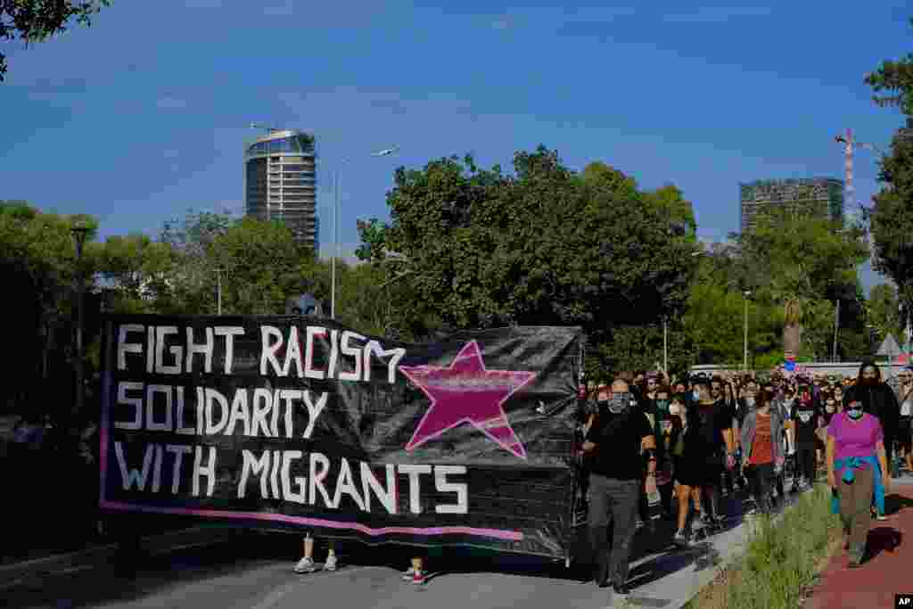 ក្រុមបាតុករ​ដែល​ដើរក្បួន​គាំទ្រ​ដល់​ជនចំណាកស្រុក​ដែល​ត្រូវ​បាន​ឃុំខ្លួន​នៅ​ប្រទេស​ស៊ីប (Cyprus) បង្ហាញ​ពី​សាមគ្គីភាព​របស់​ពួកគេ​ដល់​លោក George Floyd ដែល​បាន​ស្លាប់។ ការ​ដើរក្បួនេះ ធ្វើ​ឡើង​នៅ​រដ្ឋធានី​នៃ​ប្រទេស​ស៊ីប​នៅ​ថ្ងៃអាទិត្យ​ទី ៣១ ខែឧសភា ឆ្នាំ ២០២០។ (AP) 