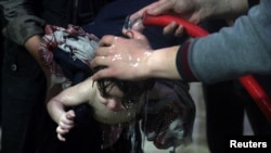 FILE - A child is treated in a hospital in Douma, eastern Ghouta, near Damascus, Syria, after a suspected chemical attack, April 7, 2018. (White Helmets/Reuters TV)