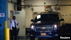 FILE - A car reportedly carrying the body of financier Jeffrey Epstein arrives at the medical examiner's in New York City, Aug. 10, 2019. 