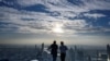 Two men enjoy the city skyline view on the 314-meter high rooftop terrace of the Mahanakhon building in Bangkok on Nov. 11, 2020.