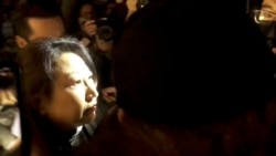 Hong Kong Justice Secretary Teresa Cheng walks as protesters surround her in London, Nov. 14, 2019, in this still image from video obtained via social media.