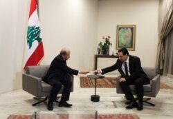 Lebanon's Prime Minister Hassan Diab submits his resignation to Lebanon's President Michel Aoun at the presidential palace in Baabda