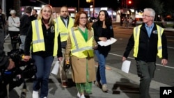 Los Angeles City Council President Paul Krekorian, right, and other officials walk on the street at the start of the annual homeless count in the North Hollywood section of Los Angeles Jan. 23, 2024.