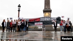 FILE - Reporters Without Borders activists in Paris demonstrate against restrictions on the press in Egypt and call for the release of detained journalists there, Oct. 24, 2017. Dozens of journalists gathered recently in Cairo to show solidarity with jailed colleagues. 