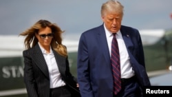 U.S. President Donald Trump and first lady Melania Trump board Air Force One as they depart Washington on campaign travel to participate in the first presidential debate with Democratic presidential nominee Joe Biden in Cleveland, Ohio.