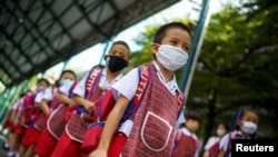 Kindergarten students attend a rehearsal for social distancing and measures to prevent the spread of the coronavirus disease (COVID-19) ahead of nationwide schools reopening in Bangkok, Thailand, June 23, 2020. 