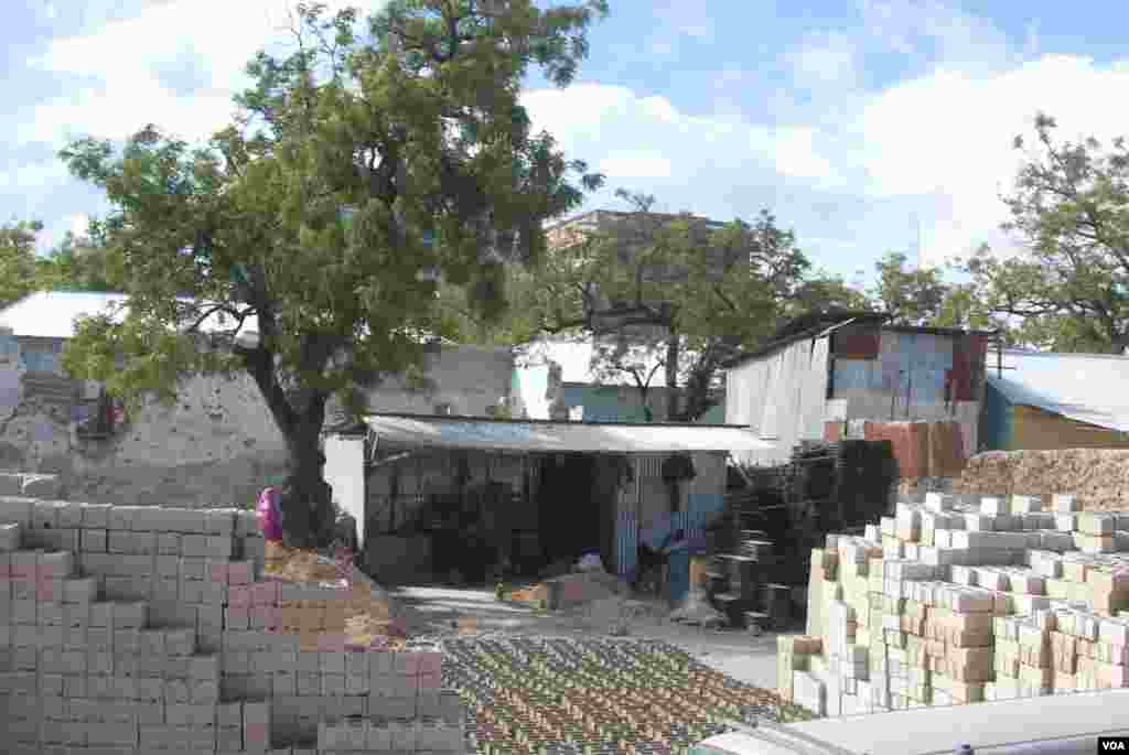 Cinderblock factories are doing big business all over the city. (Pete Heinlein/VOA)
