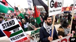 FILE - Pro-Palestinian demonstrators march during a visit by U.S. President Joe Biden in Warren, Michigan, Feb. 1, 2024. Vice President Kamala Harris and "uncommitted" Arab American Democrats are in discussions as the Democratic National Convention is set to begin Aug. 19, 2024.