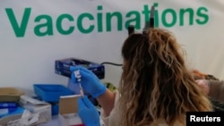 The AstraZeneca vaccine is prepared in the COVID-19 vaccination center at the Odeon Luxe Cinema in Maidstone, Britain, Feb. 10, 2021. 