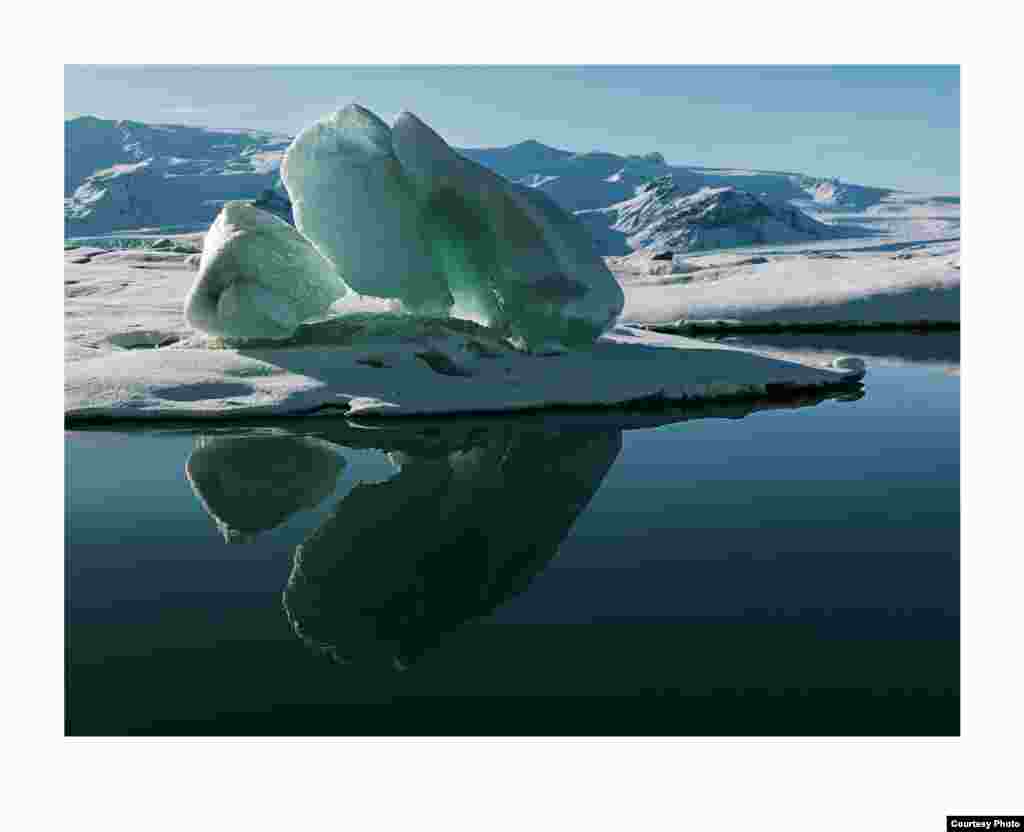 Lake Jökulsárlón shimmers with the reflection of a magnificent iceberg. (Feo Pitcairn Fine Art)