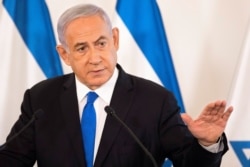 FILE - Israeli Prime Minister Benjamin Netanyahu gestures as he speaks at a military base in Tel Aviv, Israel, May 19, 2021.
