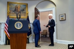 FILE - Joe Biden and Education Secretary Miguel Cardona speak with each other after a media event at the White House earlier in 2023. (AP Photo/Evan Vucci)