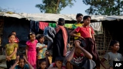 FILE - Rohingya Muslims, who crossed over from Myanmar into Bangladesh, wait to collect aid at Kutupalong refugee camp in Ukhiya, Bangladesh, Dec. 21, 2017. 