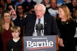 Democratic presidential candidate Sen. Bernie Sanders, I-Vt., with his wife Jane O'Meara Sanders, speaks to supporters at a caucus night campaign rally in Des Moines, Iowa, Feb. 3, 2020.
